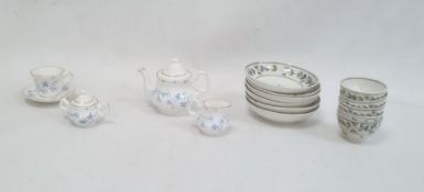 Set of 18th century child's tea bowls and saucers decorated with bands of leaves and blue flowers,