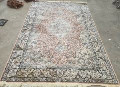 Modern Eastern-style rug, peach ground foliate decorated field with pale green central medallion and