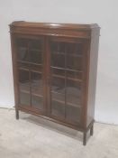 Oak bookcase, two astragal glazed doors enclosing shelves, square section supports, 90cm x 113cm