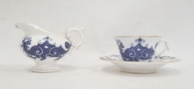 Royal Worcester cup and saucer decorated with blue dragons on a white ground, with gilt rim, date