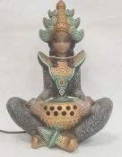 Modern figural table lamp modelled as a seated dancer with headdress, 43cm high