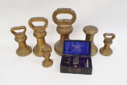 Set of five brass weights from 14lb to 1lb, another, brass and a Star safety razor in case