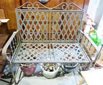 A painted metal folding garden bench