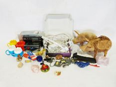 Box of various household items to include two wooden pig ornaments, a quartz radio, etc