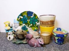 Pair of Poole pottery dolphins, three cut glass decanters, an embossed copper magazine rack,