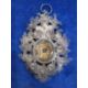 Victorian silver filigree reliquary pendant with central oval glass enclosing writing on paper - Image 1 of 2