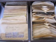 Many hundreds of envelopes with loose stamps from a variety of countries, mainly GB, in two drawer