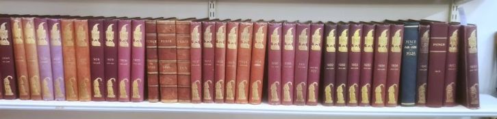 Complete run of Punch magazine, mainly red bindings with gilt and blindstamped decorations to