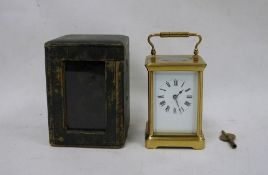 Brass and glass carriage clock with Roman numerals to the dial, in leather carry case