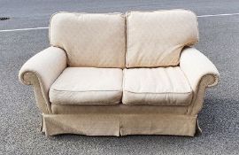 Modern two-seat sofa in cream upholstery