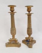 Pair brass candlesticks, each with beaded sconce, petal border to the reeded acanthus decorated