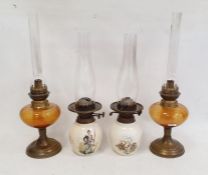Two pottery and two brass and glass oil lamps (4)