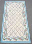 Three modern rugs, cream ground with blue ribbon trellis decoration, various sizes