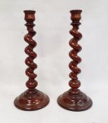 Pair of stained and turned wood candlesticks, each with spirally turned column, 44cm high (2)