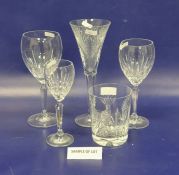 Four Waterford cut tumblers, oval medallion and bow decorated, five matching flared champagne flutes