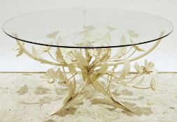 Modern coffee table with glass top and Italian-style cream painted floral spray base, 85cm diameter