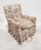 Late Victorian armchair in cream ground loose covers, on square section tapering front legs to brown
