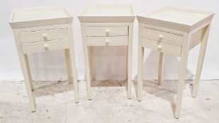 Set of three 20th century side tables with cream-painted tray tops, two drawers, on square section