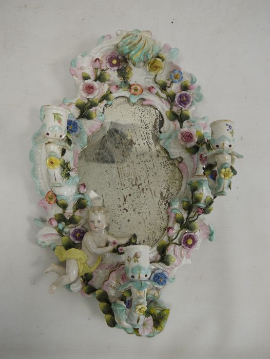 19th century porcelain wall mirror with three candle sconces, floral encrusted decoration and relief