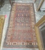 Eastern rug with blue ground central field with hooked repeating medallions, stepped border, 196cm x