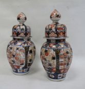 Pair Japanese Imari vases, each ovoid and ribbed with typical decoration in panels, having high