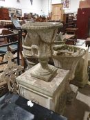 Stone urn on a plinth base together with two further stone urns (3)