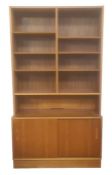 Mid 20th century Danish Hundevad bookcase with nine shelves above pair of sliding panelled