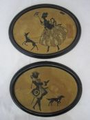 Pair of oval silhouette embroidered pictures depicting male and female figures walking a dog, 16.5cm