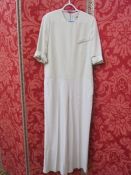 Cream Stella McCartney jumpsuit, a Stella McCartney black wool skirt and a Stella McCartney grey mac