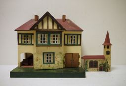 A Triang painted doll's house, 42cm high with wooden painted clock tower (2)