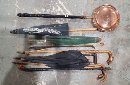 Quantity of walking sticks, two paper parasols, etc