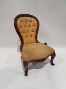 Victorian-style low chair in yellow upholstered seat and back, on carved front legs