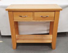 20th century oak hall table, the rectangular top above two drawers over shelved undertier, W 85cm