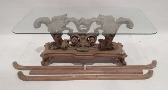 Coffee table, the rectangular glass top with rounded corners, on heavily carved and moulded base