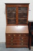 20th century mahogany bureau bookcase with moulded cornice above two astragal glazed doors enclosing