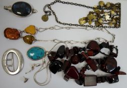 Silver coloured wirework necklace set with three amber nuggets, a silver buckle of plain oval form