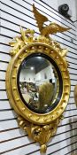 20th century circular wall mirror surmounted by eagle, with a carved giltwood frame, the convex