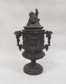 Cast metal two-handled urn decorated with a continuous scene of cherubs in a Bacchanalian feast, the