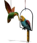 Papier mache model of a parrot, a papier mache model of a hummingbird and a wooden model of a