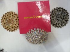 Three large Butler & Wilson circular floral diamante brooches, one in shades of white, one in shades