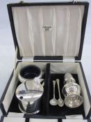 Silver three-piece condiment set by CJ Vander Ltd, viz:- cylindrical mustard pot with scallopshell