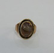 Georgian gold, enamel and agate mourning ring, oval, the cabochon agate surrounded by black and gilt