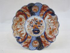 Japanese imari porcelain charger, scalloped border and decorated with flowers and brocade work in