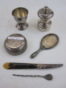 Silver pepper mill, a silver eggcup, a silver-handled tortoiseshell paper knife and sundries
