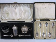Three-piece silver condiment set, cased, two silver  salt spoons and a plated set of six shell bow
