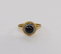 Gold-coloured metal and black banded onyx ring, set circular stone within rope borders