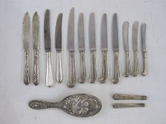 Miscellaneous silver pistol and other handled knives and a silver-backed hairbrush embossed