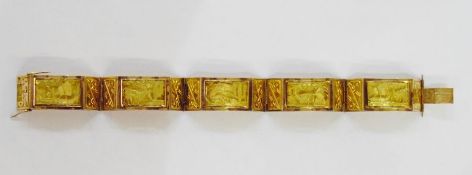 Egyptian-style gold-coloured metal bracelet panelled with relief scenes of sailing boats and camels,