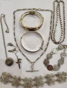 Silver-coloured metal and filigree floral necklace, a silver bangle, a threepenny bit necklace, a