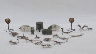 White metal box of cylindrical form with tripod base, the lift-off cover with engraved decoration,